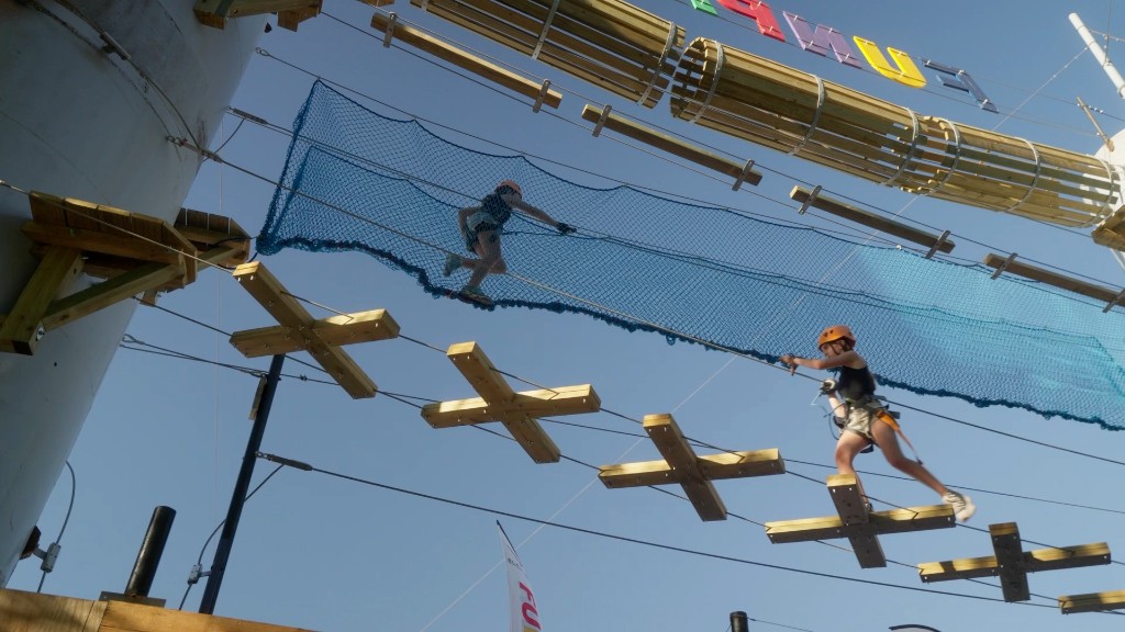 Outdoor high-ropes adventure course with safety nets and participants at La Rivera.